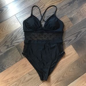One piece bathing suit with see-through cut outs